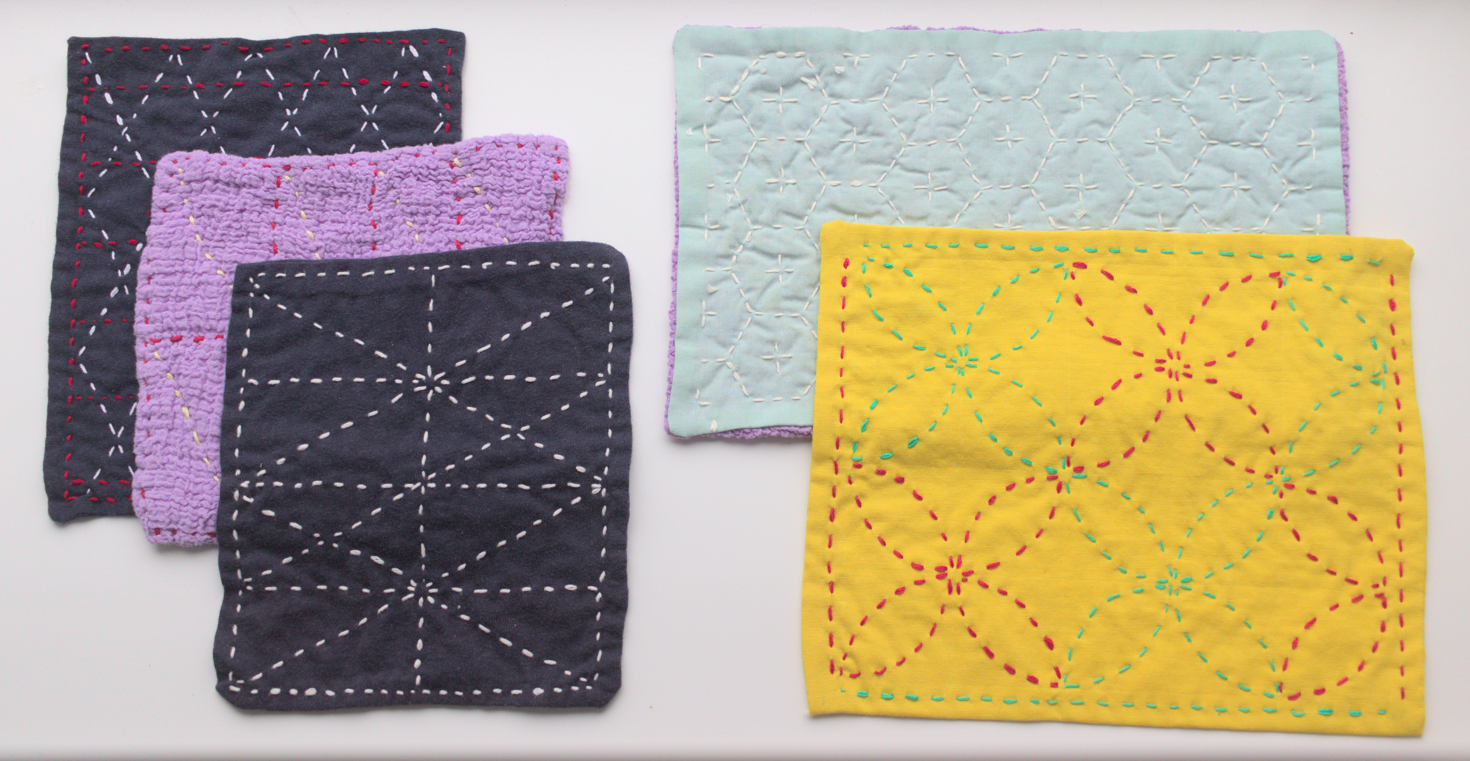 different rectangles of fabric, layered and stitched with contrasting sashiko patterns